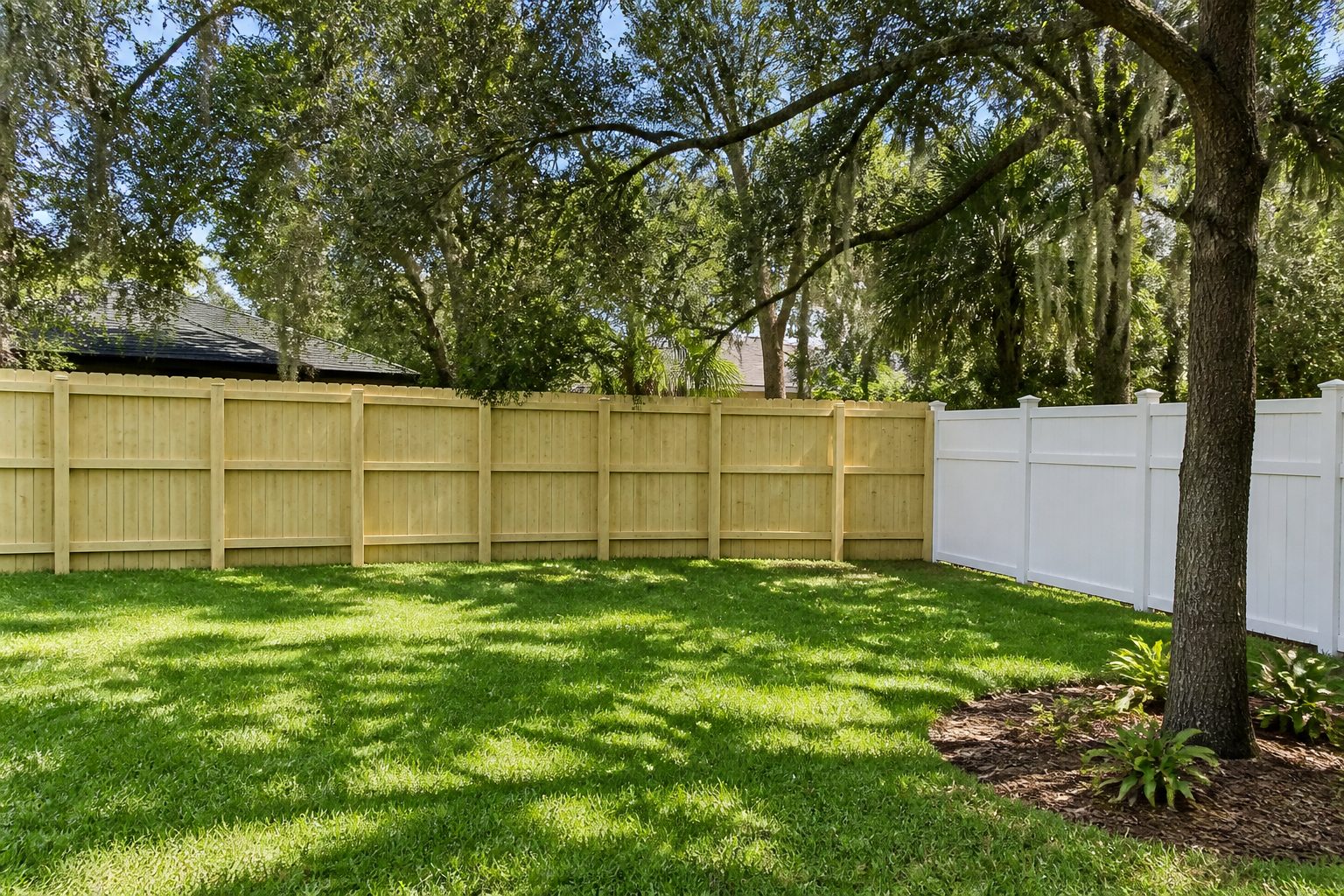 Demonstration photograph of a brightened wood and vinyl fence. Example service card, not a live customer site.