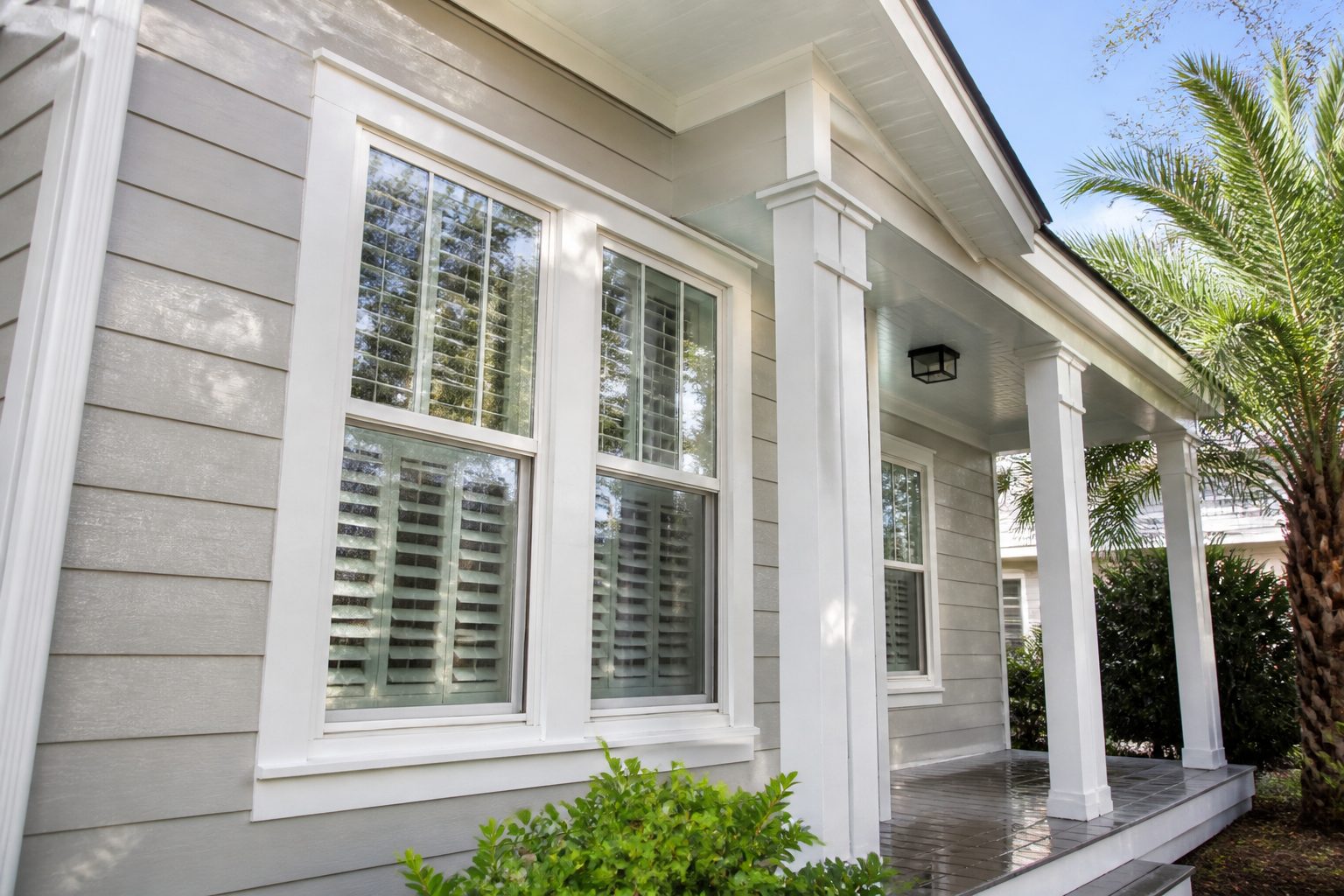 Demonstration photograph of freshly washed house siding and porch. Example service card, not a live customer site.